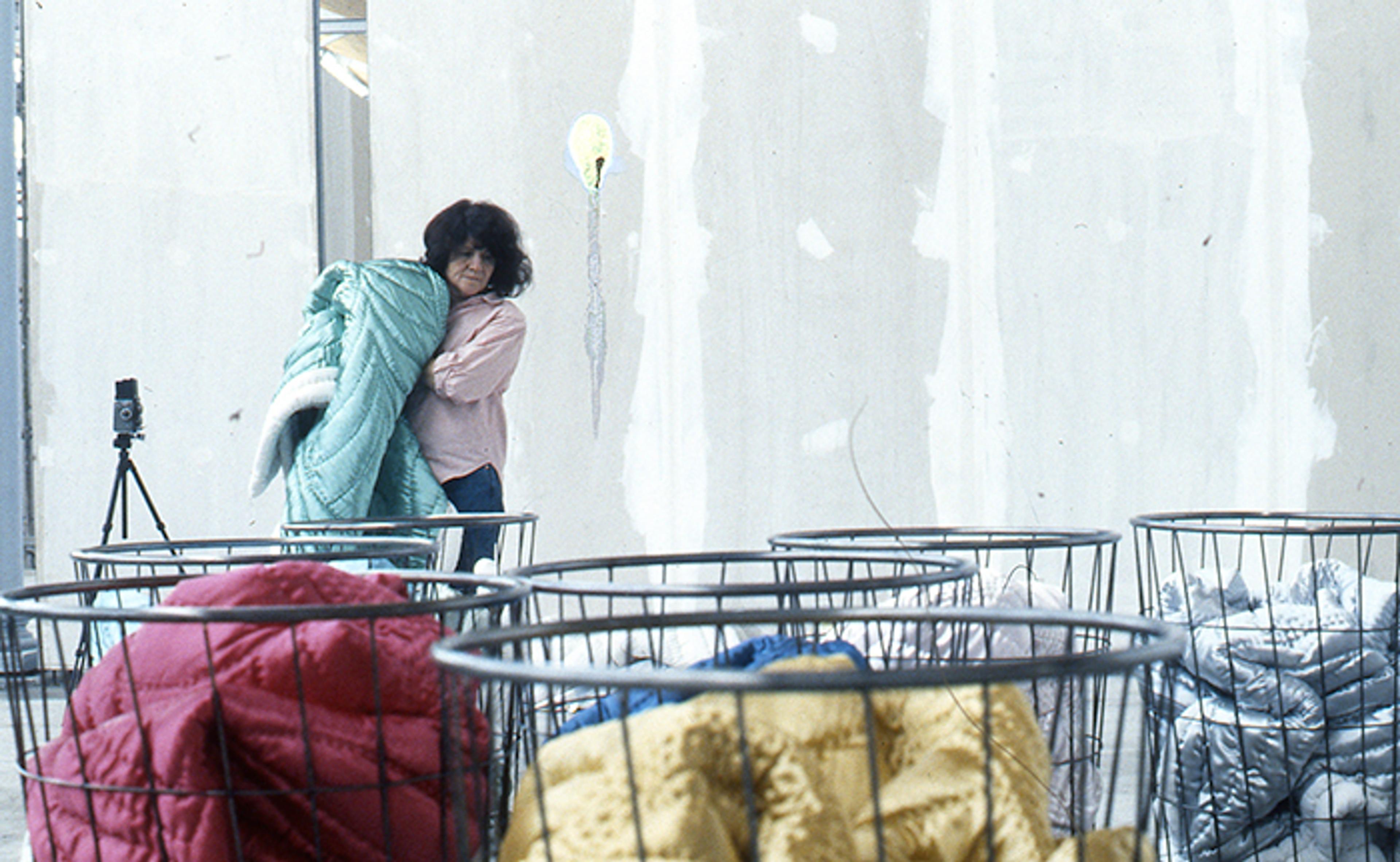 Gülsün Karamustafa while installing her work Mystic Transport , which was made for the 3rd International Istanbul Biennial, Feshane, 1992