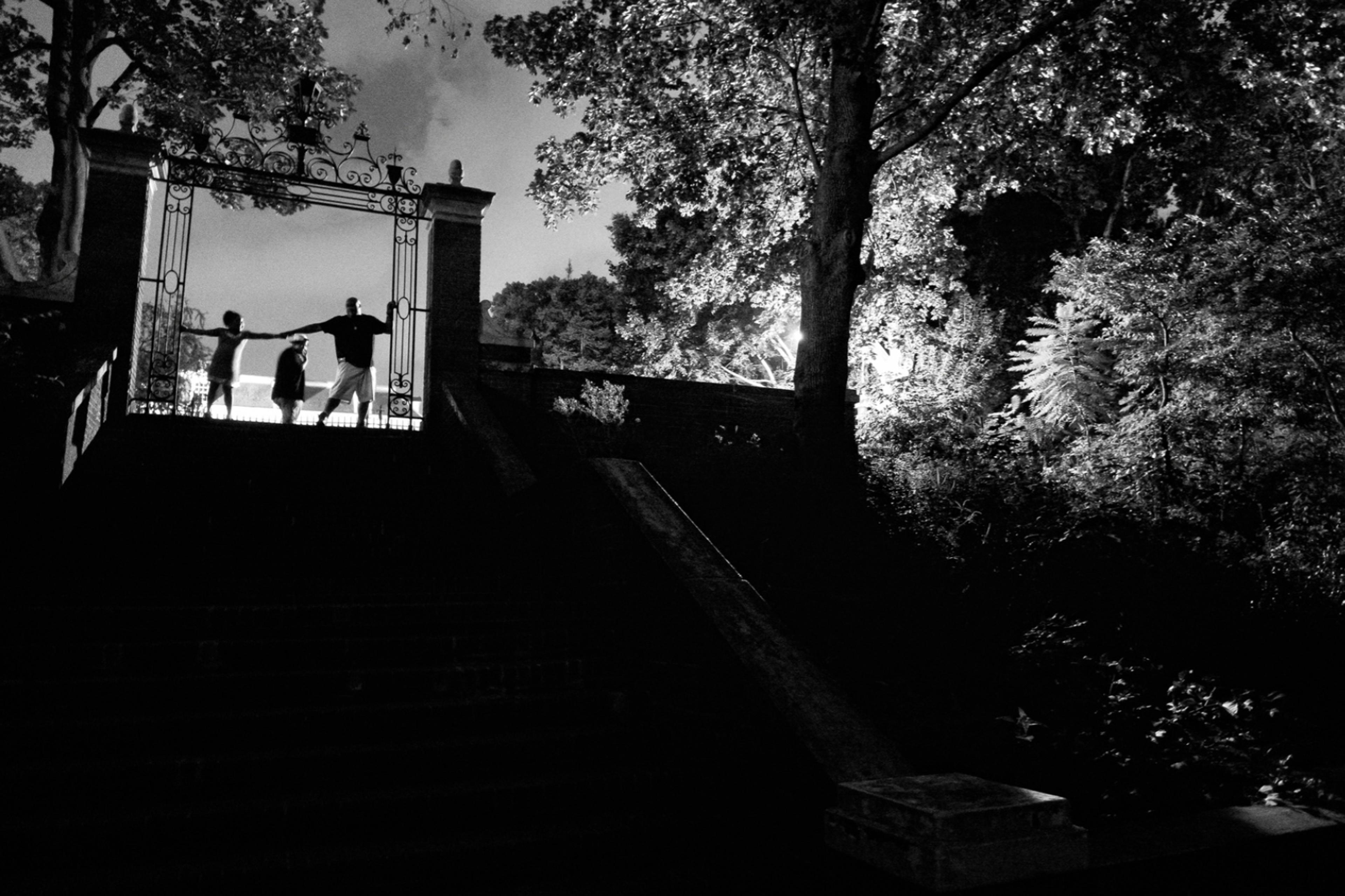 Zun Lee, “Billy Garcia on a nighttime walk through Van Corlandt Park with Esmeralda and Jeremy. Bronx, NY. September 2021” from the series Father Figure